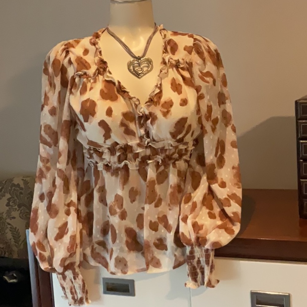 Super feminine Peplum with ruffles and balloon sleeves semi sheer blouse.